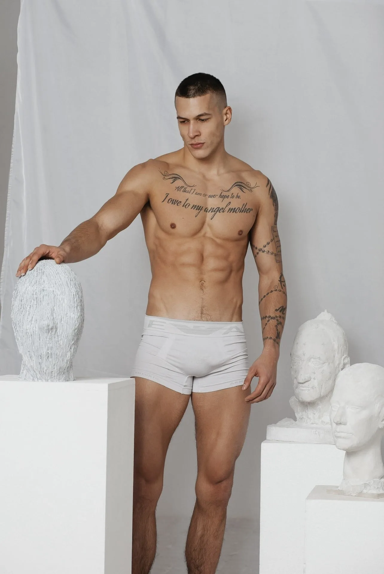 Matija Radosevic photographed among plaster busts